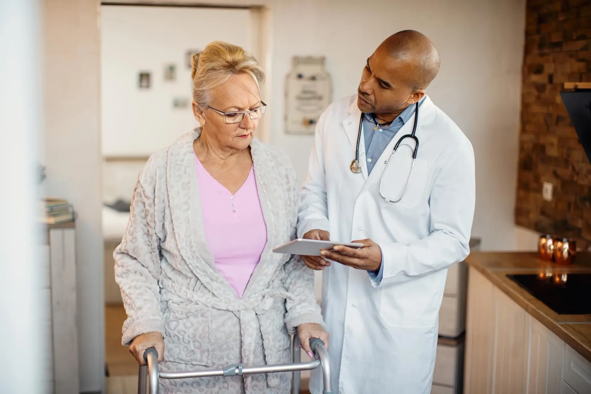 Doctor supporting an older person after hospital discharge