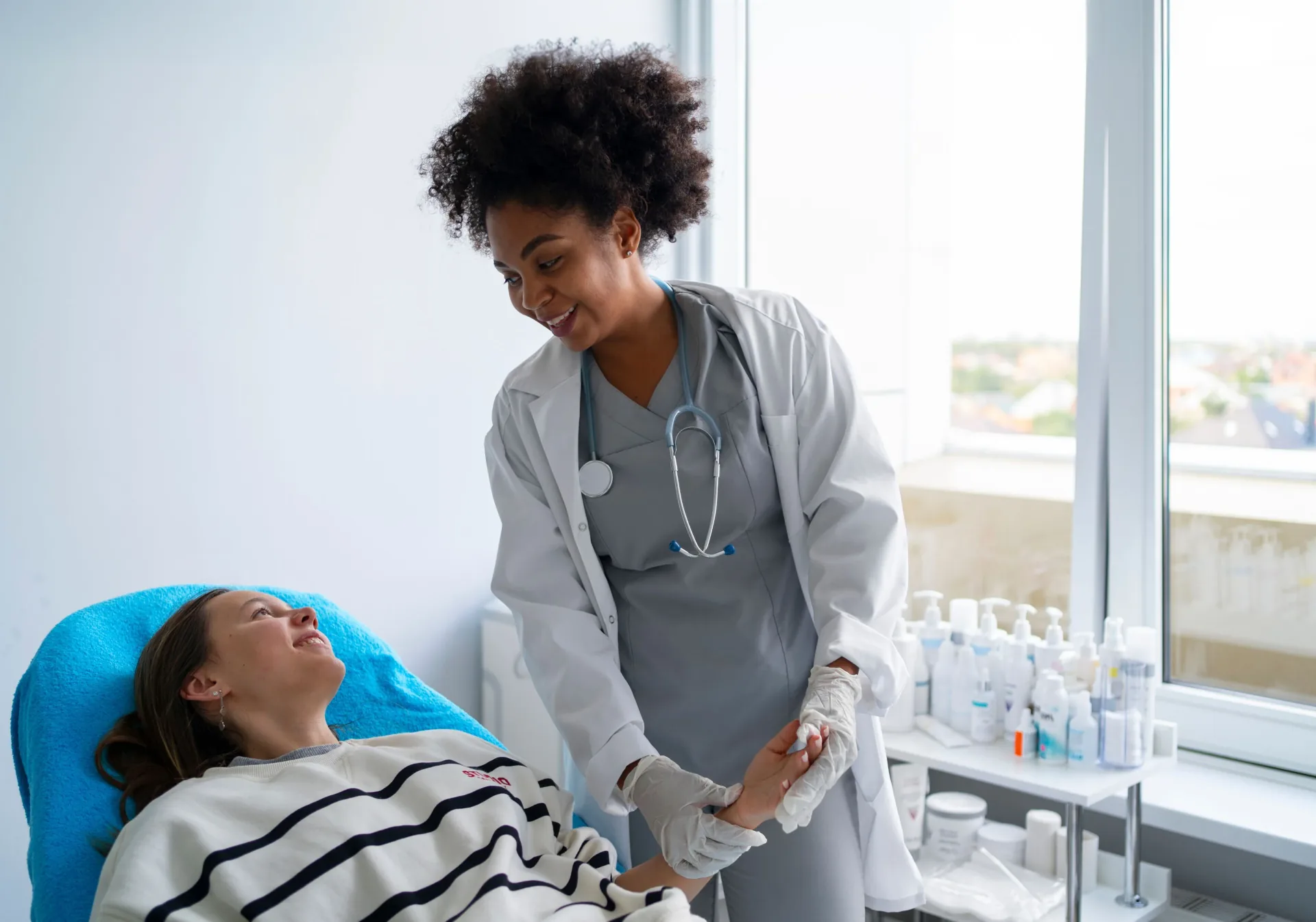 Care worker supporting a person in bed