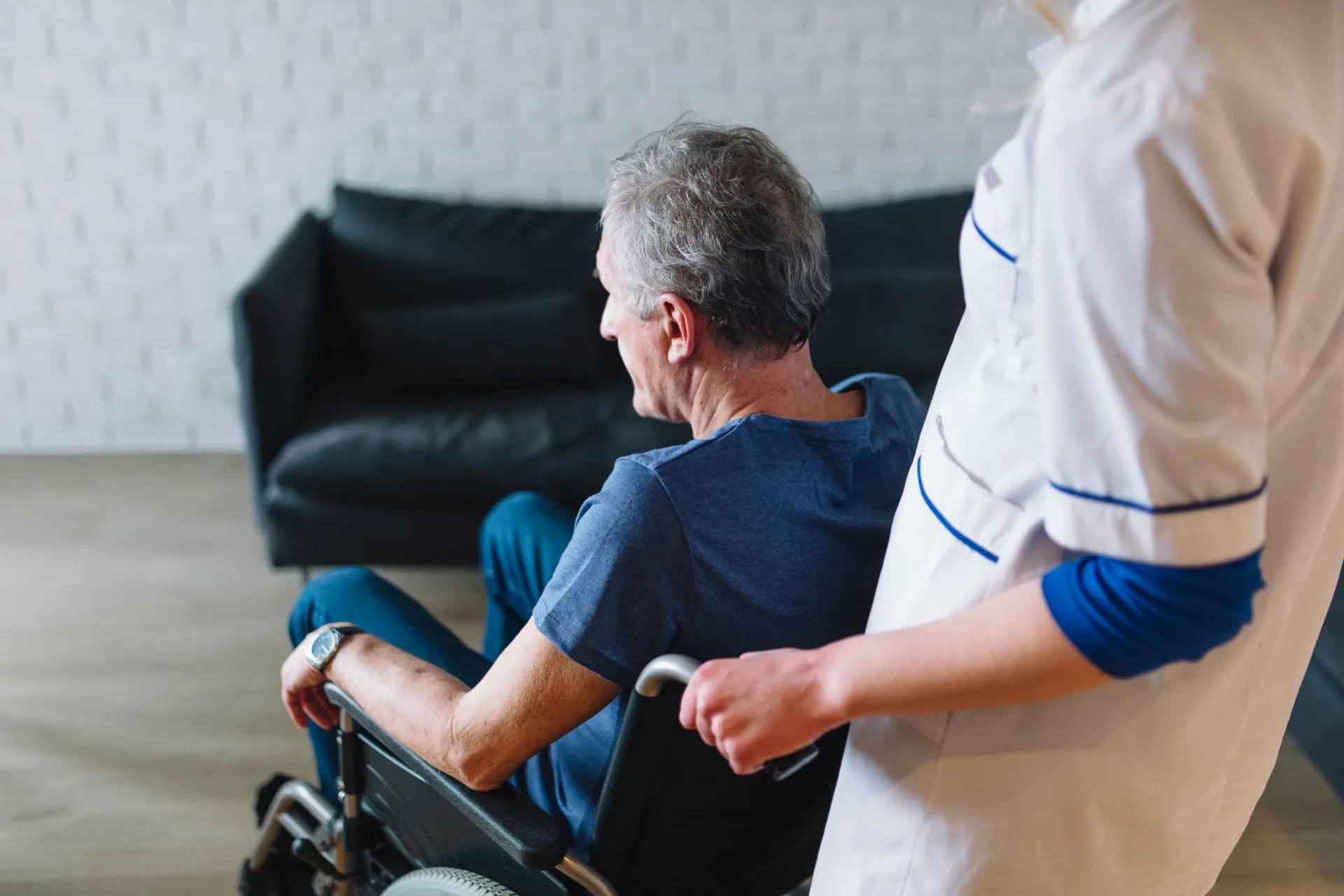 Care worker supporting an older person with Parkinson's disease