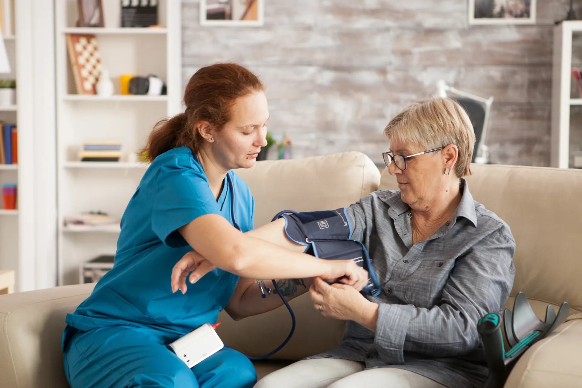 Care worker checking an older person at home